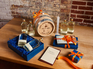 Whiskey Aging Kit by Kings County Distillery, featuring bottles of moonshine paired with aging barrels